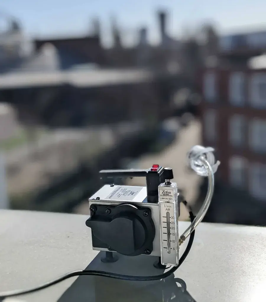 An air sampling pump set up outdoors to take the control sample
